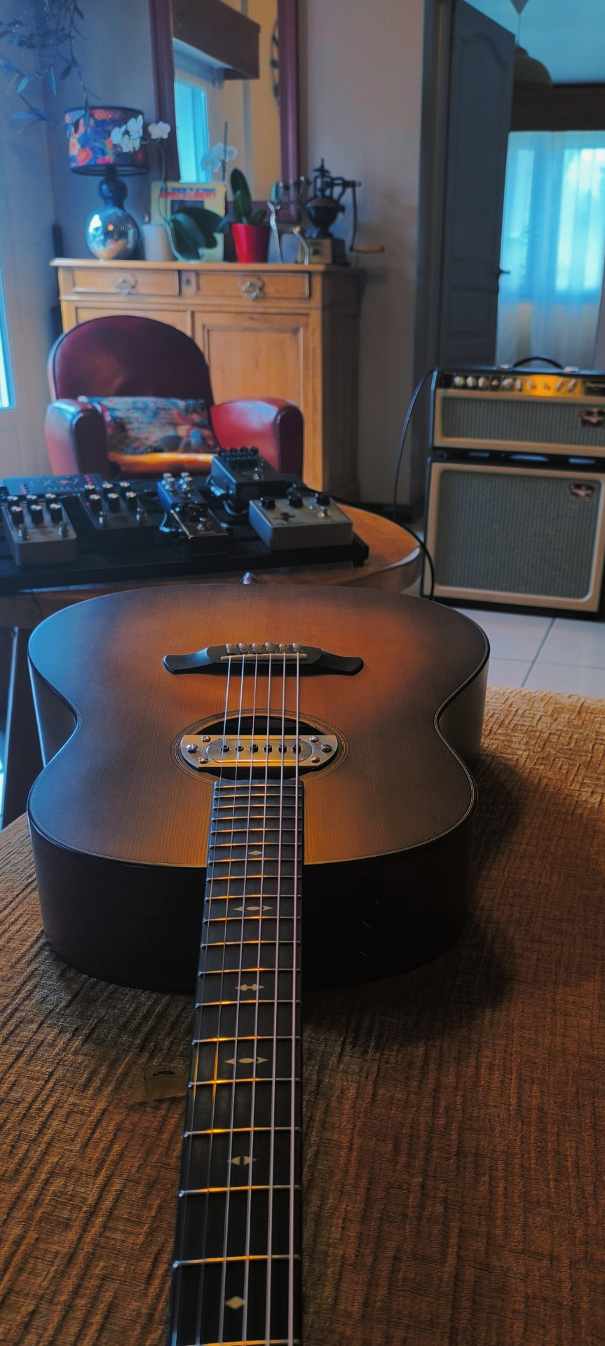 Guitare acoustique posée sur une table, ambiance intime